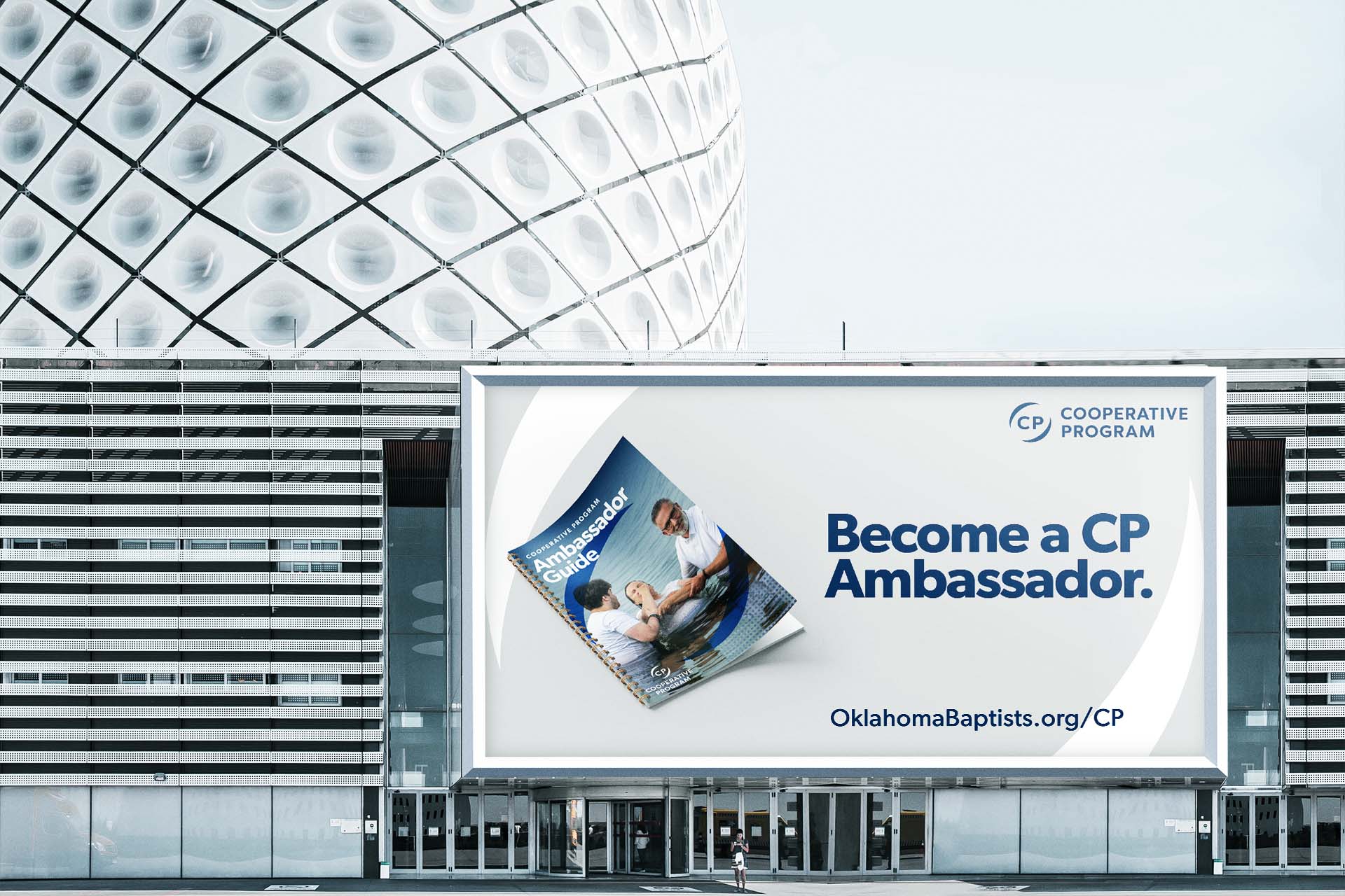 A billboard over an empty courtyard, encouraging viewers to become a Cooperative Progarm ambassador.