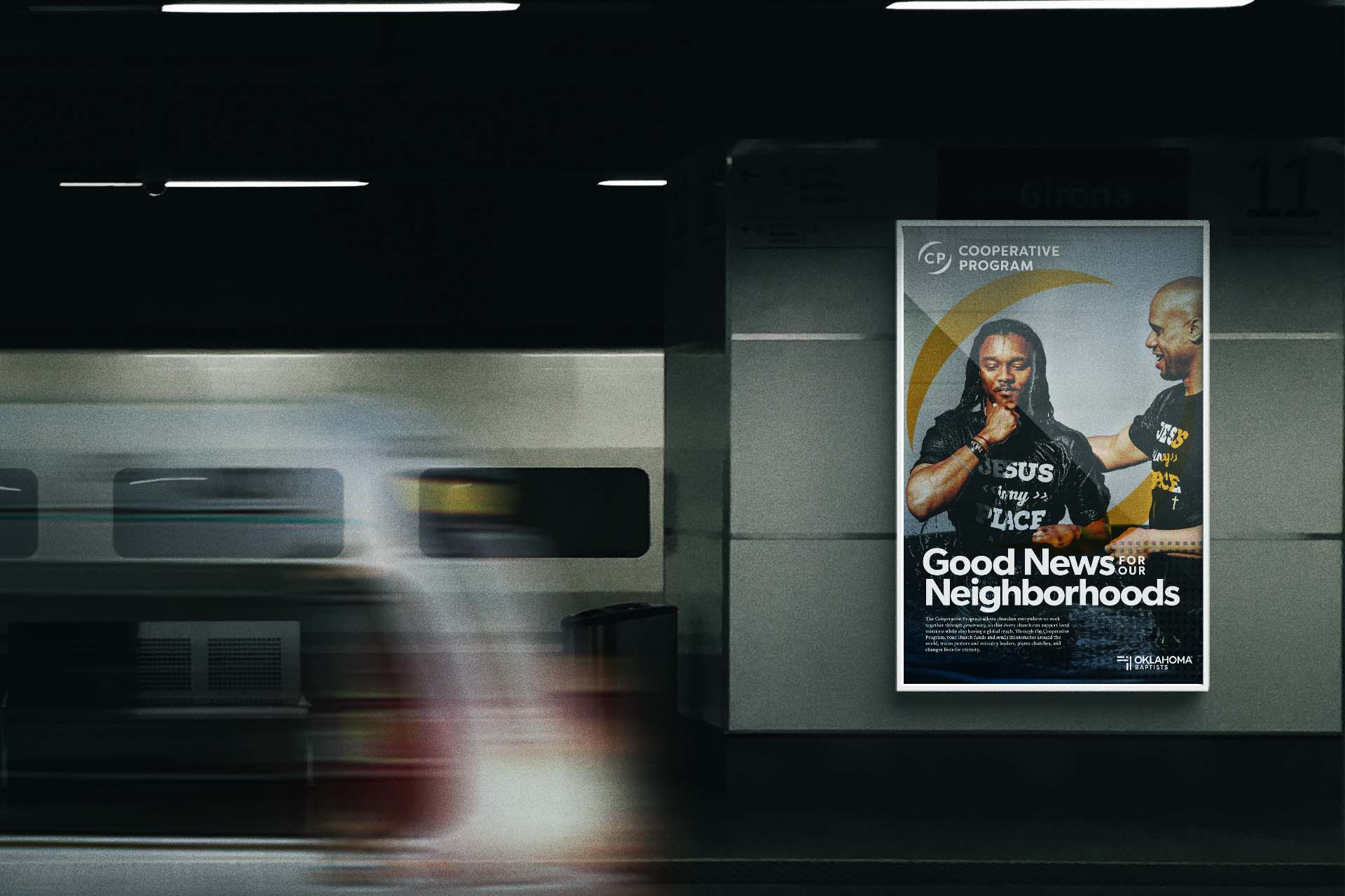 A poster displayed in a dark subway, showing a young man being baptized at a NAMB-funded church plant.
